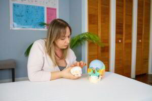 Meaghan demonstrating craniosacral technique with an infant skull model