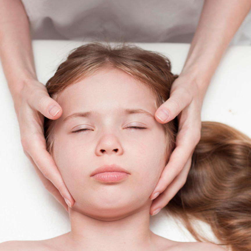 Craniosacral treatment session on a child's head