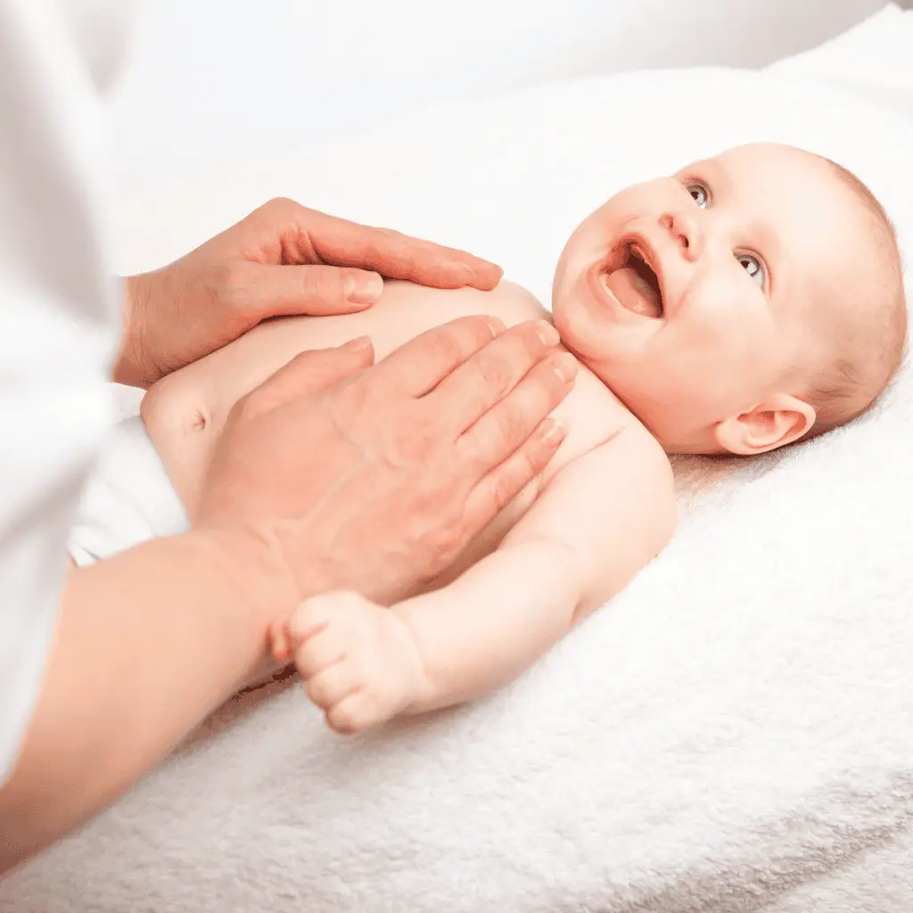 Baby receiving craniosacral therapy for improved development and relaxation.