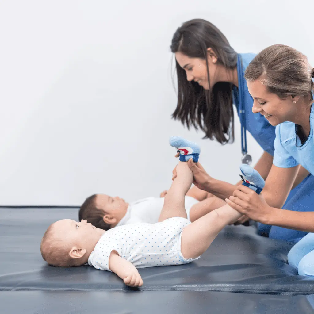 Pediatric craniosacral therapy session with healthcare professionals and infants.